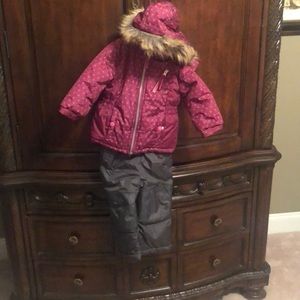Deep Pink Snow jacket and grey ski pants,